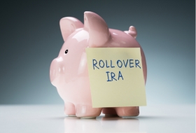 piggy bank with a sticky note that says "Rollover IRA"