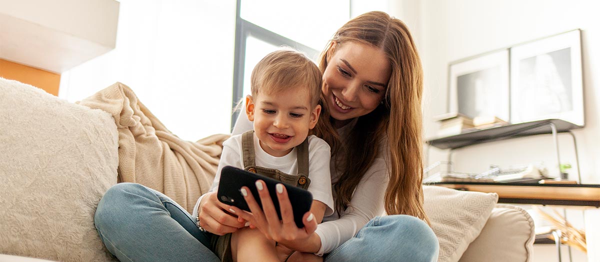 woman and child looking at phone