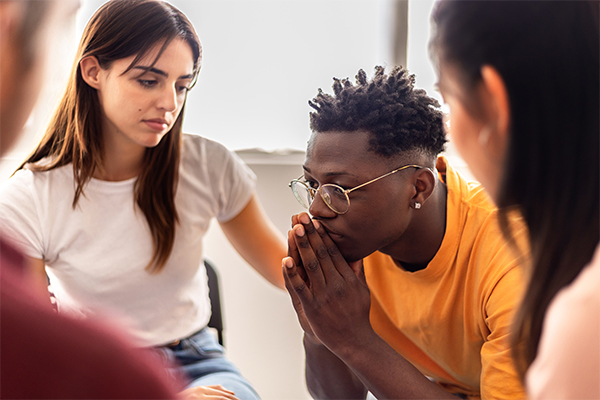Man at support group being comforted