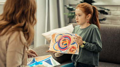 child showing her mom a drawing