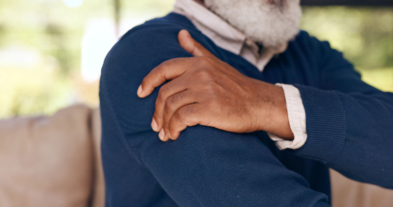 senior-man-holds-his-shoulder-in-pain