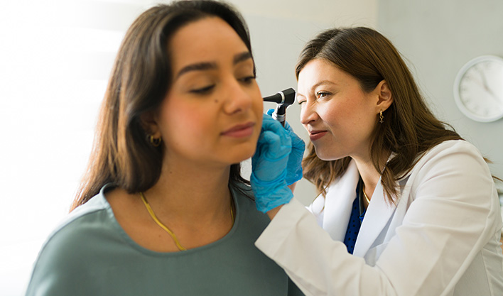 doctor preforming hearing exam on patient