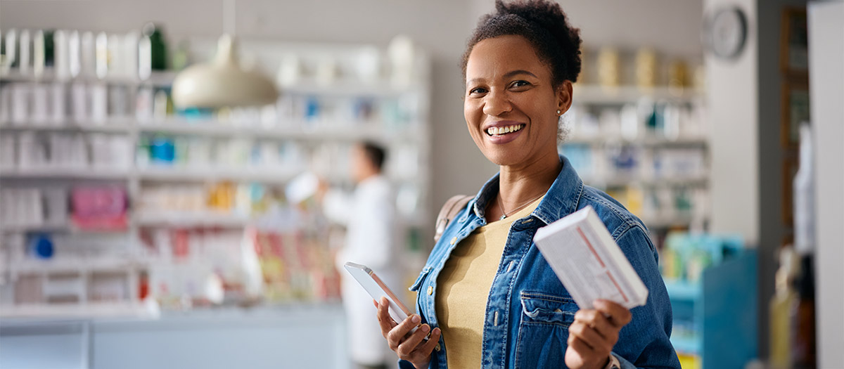 Woman picking up her prescription at the pharmacy